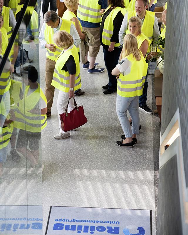 Gathering of employees with safety vests